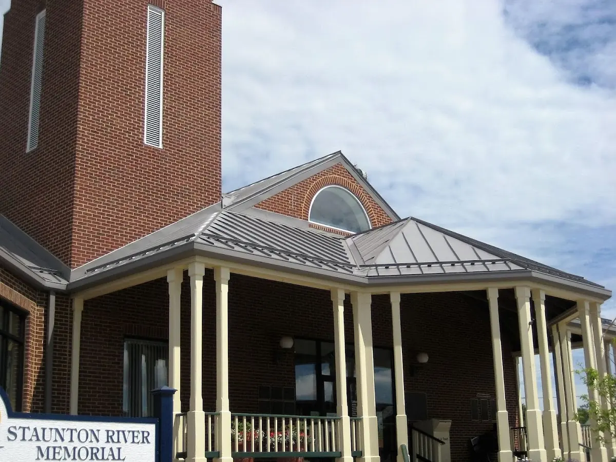 Skilled roofing craftsmen working on a residential roof in Almont
